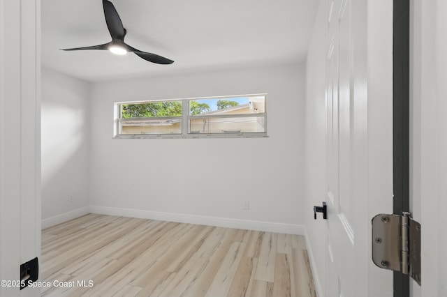 unfurnished room with ceiling fan, baseboards, and wood finished floors