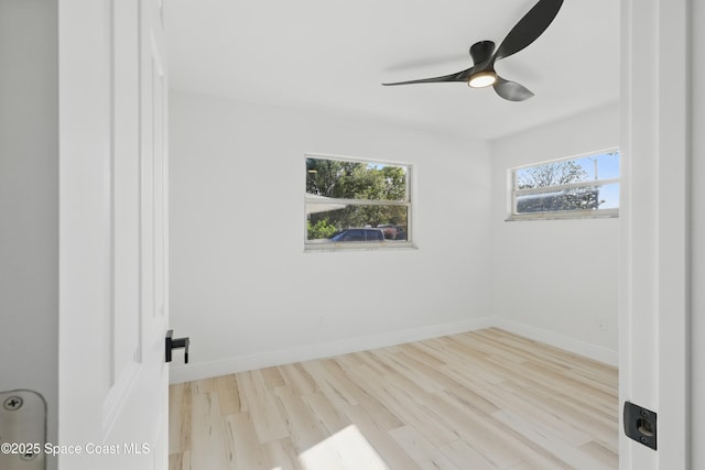 unfurnished room featuring ceiling fan, baseboards, and wood finished floors