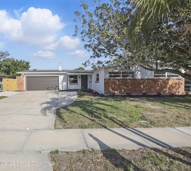 280 Antigua Dr, Merritt Island, FL 32952 - single story home with fence, a garage, a front yard, brick siding, and driveway