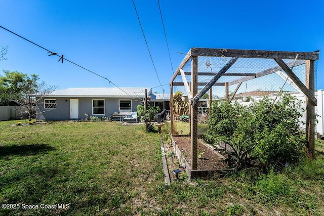 view of yard with fence and a garden