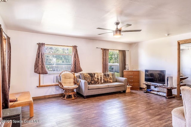 living area featuring baseboards, wood finished floors, and ceiling fan