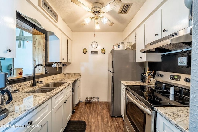 kitchen with visible vents, a sink, stainless steel range with electric cooktop, white cabinets, and under cabinet range hood