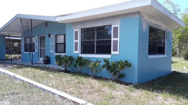 1630 S St, Titusville, FL 32780 - view of property exterior with stucco siding and fence