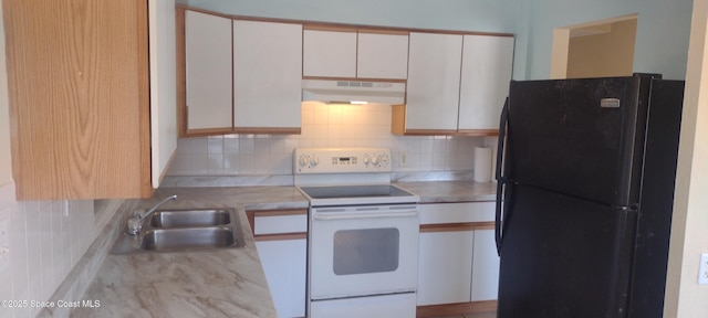 1630 S St, Titusville, FL 32780 - kitchen featuring electric range, under cabinet range hood, a sink, backsplash, and freestanding refrigerator