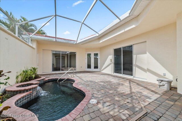 8652 Villanova Dr Unit 1001, Cape Canaveral, FL 32920 - view of swimming pool with french doors, a patio, a lanai, and a pool with connected hot tub