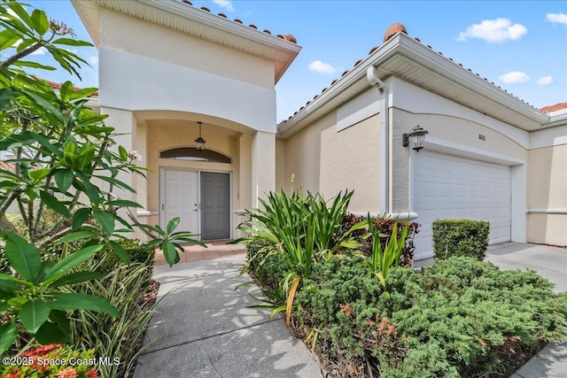 8652 Villanova Dr Unit 1001, Cape Canaveral, FL 32920 - property entrance with stucco siding and an attached garage