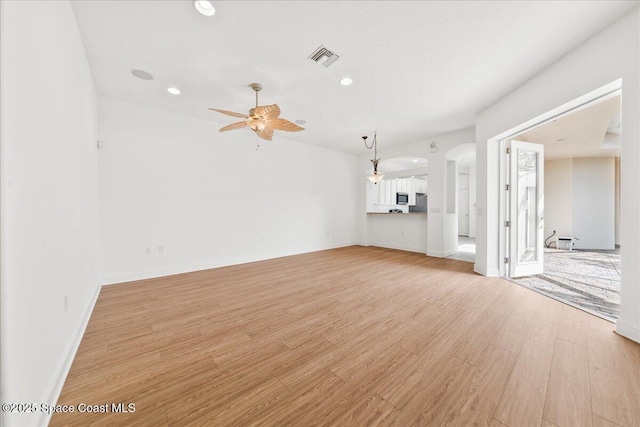 8652 Villanova Dr Unit 1001, Cape Canaveral, FL 32920 - unfurnished living room featuring ceiling fan, light wood-type flooring, recessed lighting, baseboards, and arched walkways
