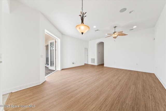 8652 Villanova Dr Unit 1001, Cape Canaveral, FL 32920 - unfurnished room with arched walkways, a ceiling fan, light wood-type flooring, recessed lighting, and baseboards