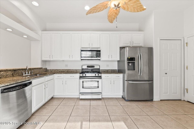 8652 Villanova Dr Unit 1001, Cape Canaveral, FL 32920 - kitchen featuring stainless steel appliances, a sink, light tile patterned flooring, white cabinets, and recessed lighting
