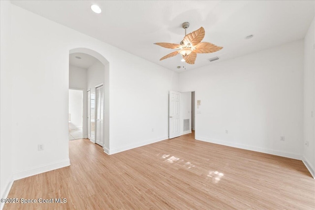 8652 Villanova Dr Unit 1001, Cape Canaveral, FL 32920 - spare room with arched walkways, a ceiling fan, light wood-style flooring, baseboards, and recessed lighting