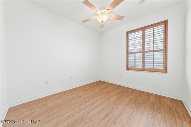 8652 Villanova Dr Unit 1001, Cape Canaveral, FL 32920 - spare room with light wood-style floors, baseboards, and a ceiling fan