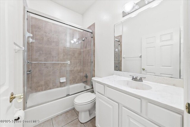 8652 Villanova Dr Unit 1001, Cape Canaveral, FL 32920 - full bathroom with toilet, tile patterned floors, vanity, and enclosed tub / shower combo