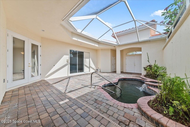 8652 Villanova Dr Unit 1001, Cape Canaveral, FL 32920 - view of swimming pool with french doors, a patio, a pool with connected hot tub, and glass enclosure
