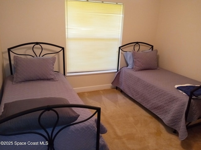 carpeted bedroom with baseboards