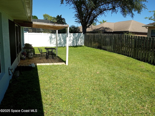 view of yard featuring a patio and a fenced backyard