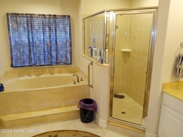 full bathroom featuring tile patterned flooring, a shower stall, a bath, and vanity