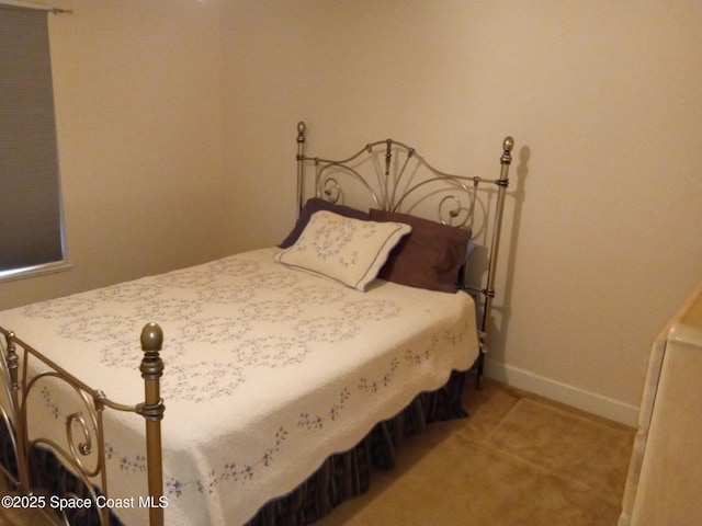 carpeted bedroom with baseboards