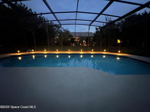 3070 Rio Plumosa N, Indialantic, FL 32903 - pool at twilight featuring an outdoor pool, a lanai, and a patio