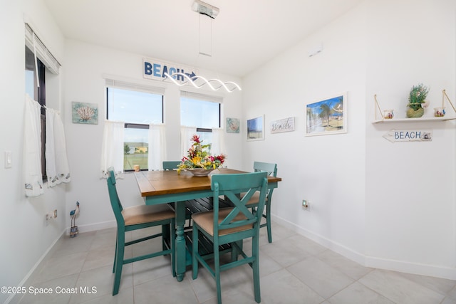 dining area with light tile patterned floors and baseboards