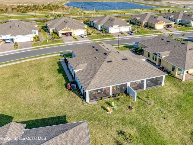 bird's eye view with a residential view and a water view