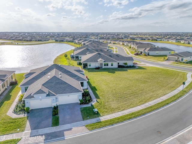 birds eye view of property with a residential view and a water view