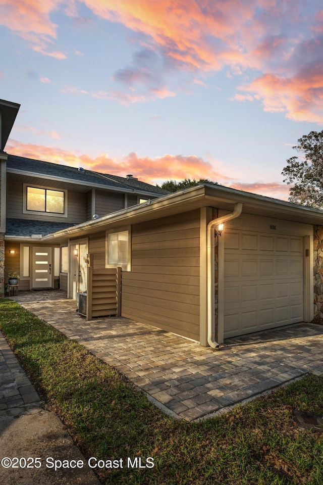 view of side of home with an attached garage