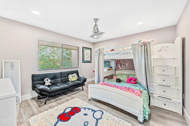 bedroom with recessed lighting, light wood-style flooring, and baseboards