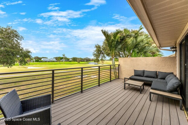 wooden terrace with outdoor lounge area and a yard