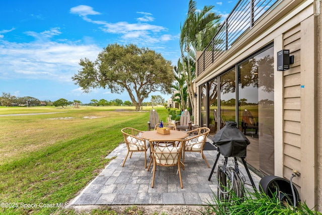 view of patio with area for grilling and outdoor dining area