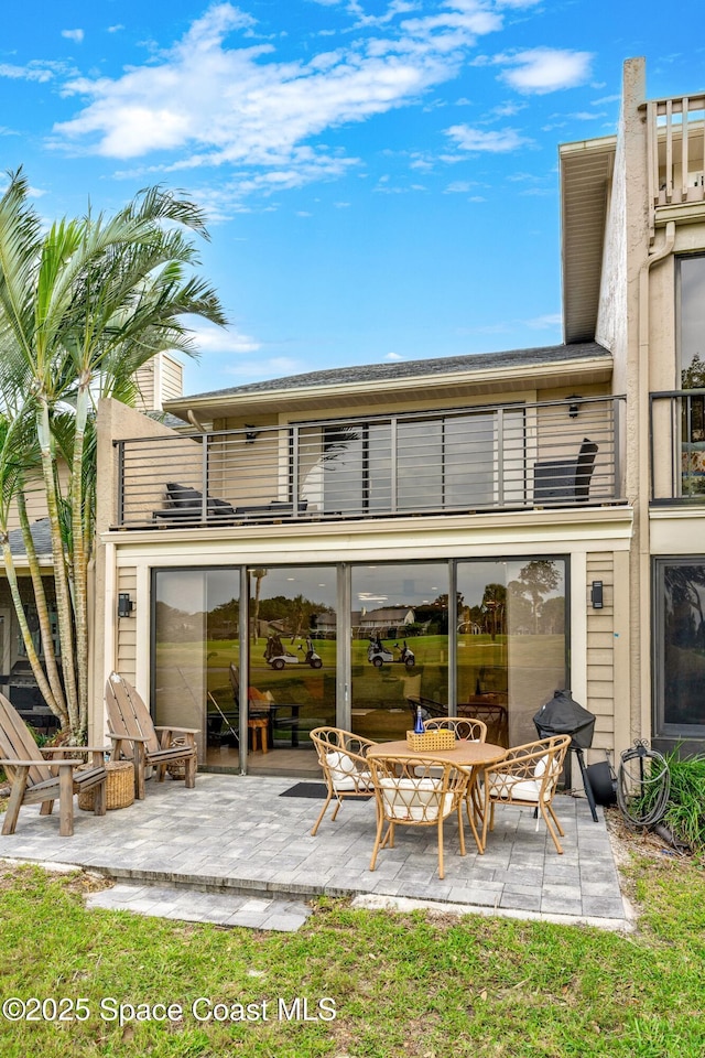 back of house with a balcony and a patio area