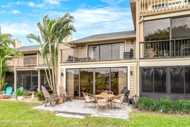 back of house featuring a balcony and a patio area