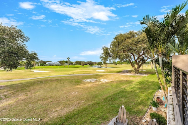 view of community featuring a lawn and golf course view