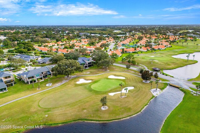 aerial view featuring a residential view, golf course view, and a water view