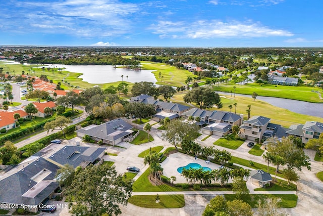 drone / aerial view with a residential view, a water view, and golf course view