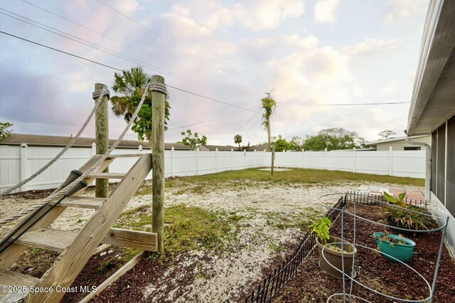 view of yard with a garden and a fenced backyard