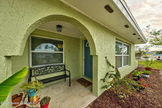 doorway to property with stucco siding