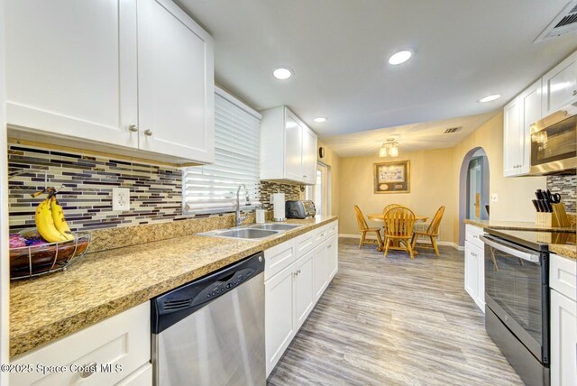 kitchen featuring white cabinetry, visible vents, appliances with stainless steel finishes, and a sink