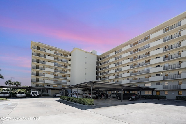 view of building exterior featuring covered parking