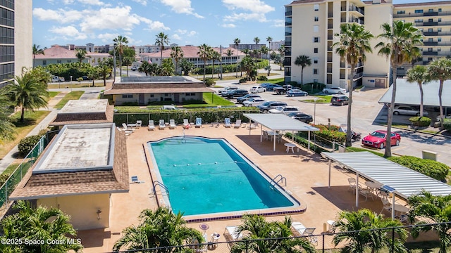 view of swimming pool featuring fence