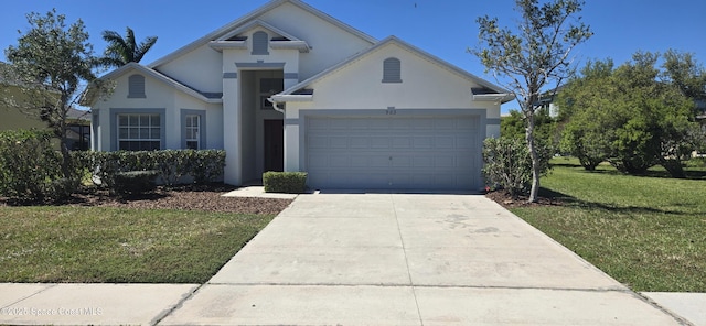 view of front of home featuring a front lawn, concrete driveway, a garage, and stucco siding