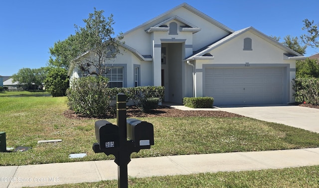 view of front of house with stucco siding, concrete driveway, a front yard, and a garage