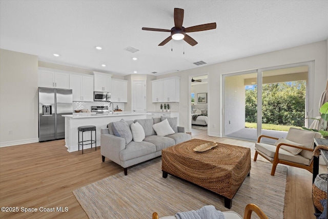 403 Fonsica St, Palm Bay, FL 32908 - living room featuring ceiling fan, light wood-style floors, baseboards, and recessed lighting