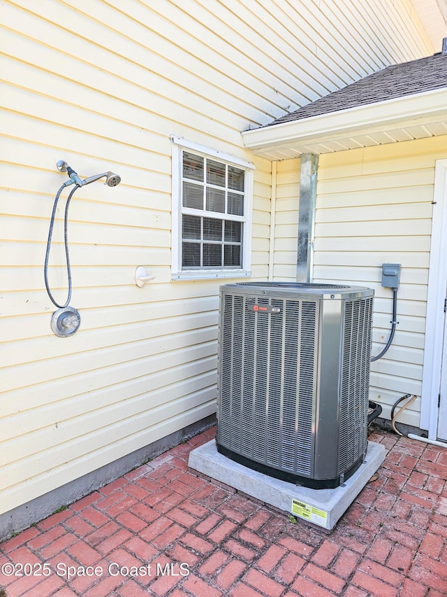 6425 Currahee Ln, Mims, FL 32754 - exterior details with a shingled roof and central AC