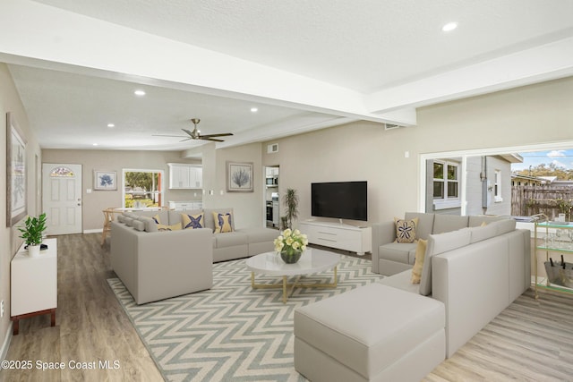 living area featuring a wealth of natural light, recessed lighting, and light wood-style floors