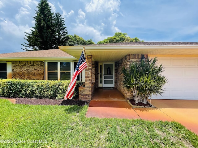 1961 Bradway St NE, Palm Bay, FL 32905 - entrance to property with brick siding, an attached garage, and a lawn