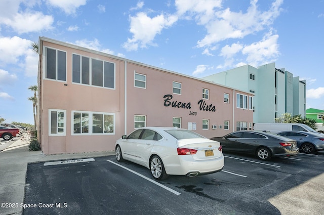 view of property featuring uncovered parking