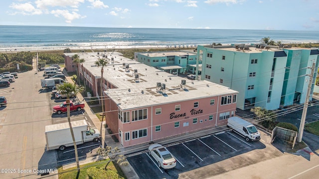 birds eye view of property with a beach view and a water view