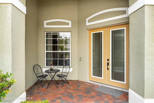 366 Gardendale Cir SE, Palm Bay, FL 32909 - entrance to property with stucco siding, french doors, and a patio area
