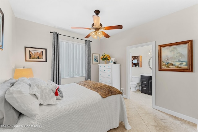 366 Gardendale Cir SE, Palm Bay, FL 32909 - bedroom with baseboards, connected bathroom, ceiling fan, and light tile patterned flooring