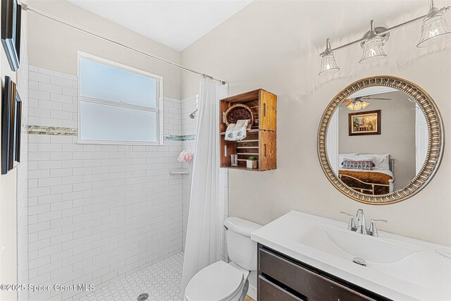 366 Gardendale Cir SE, Palm Bay, FL 32909 - bathroom with a tile shower, toilet, ceiling fan, and vanity